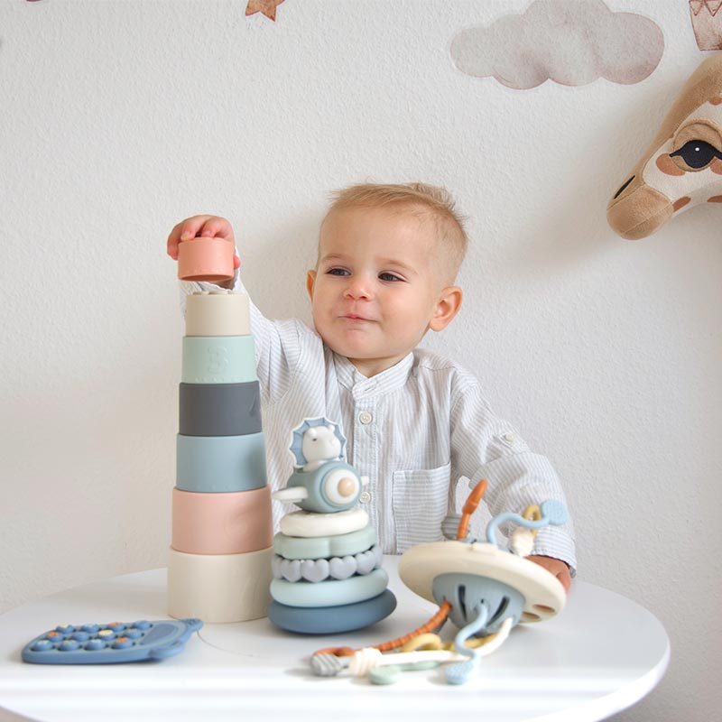 A baby is palying Moonkie Stacking toys