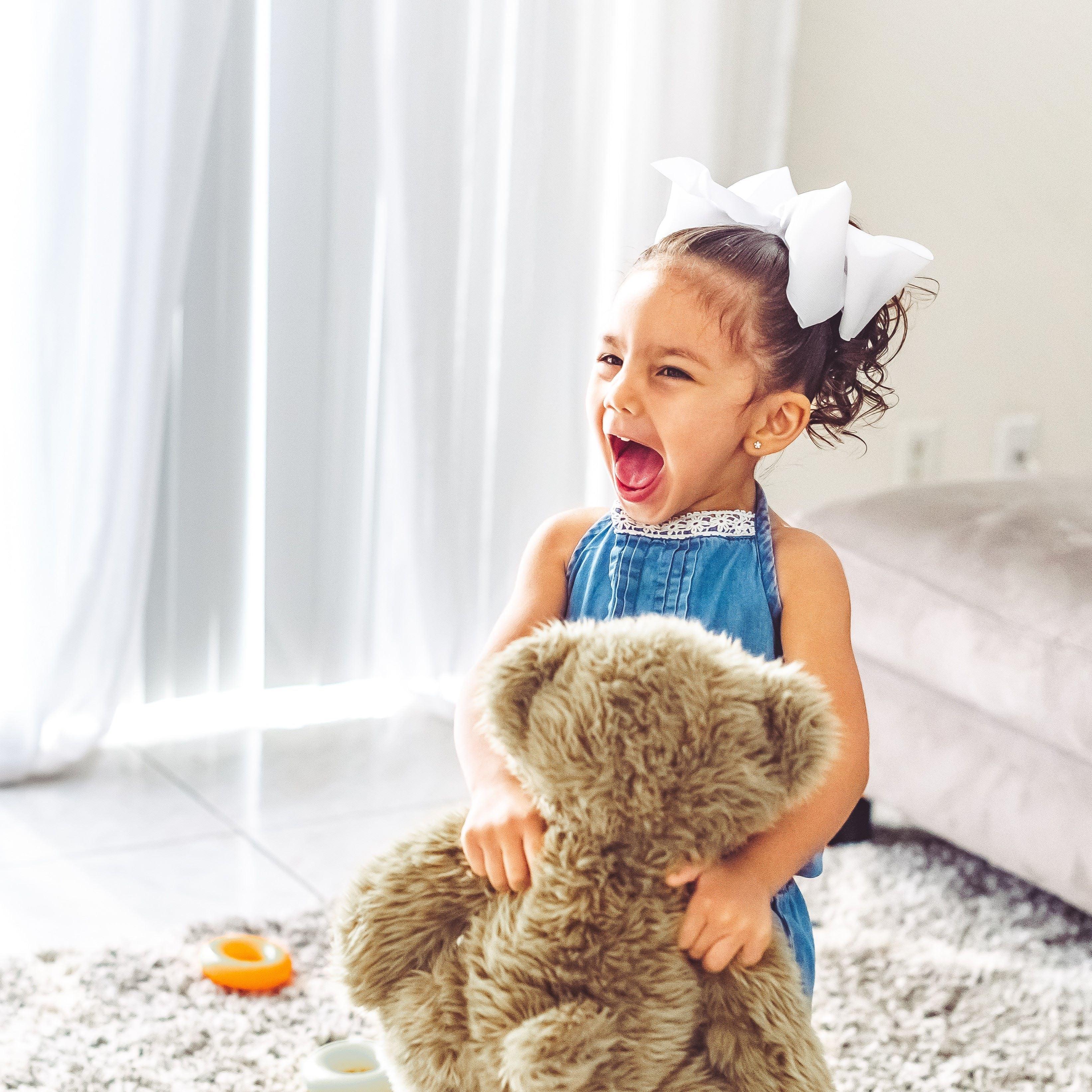 Wild, screaming little girl toddler playing at home