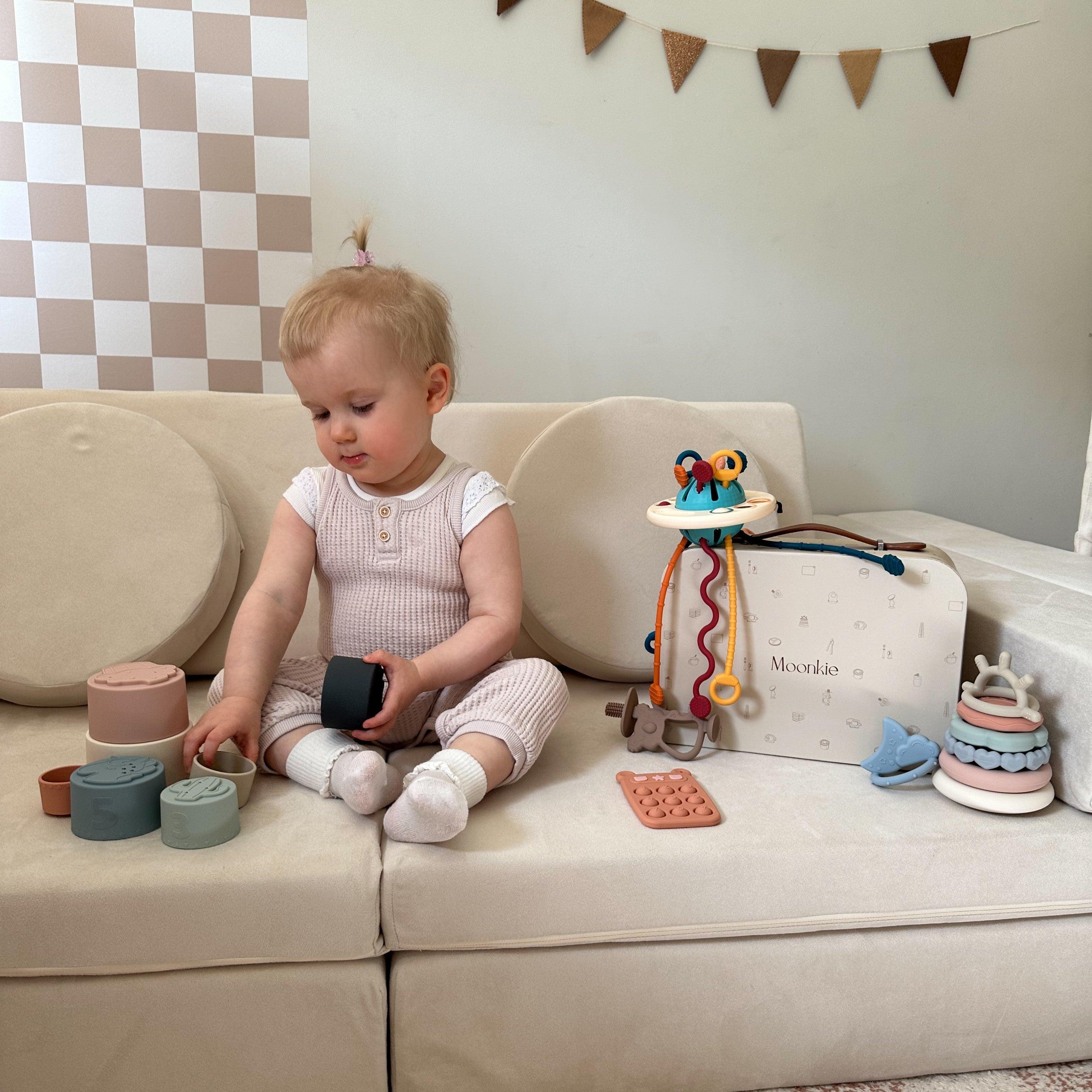 A toddler is playing Moonkie's Sensory Toys