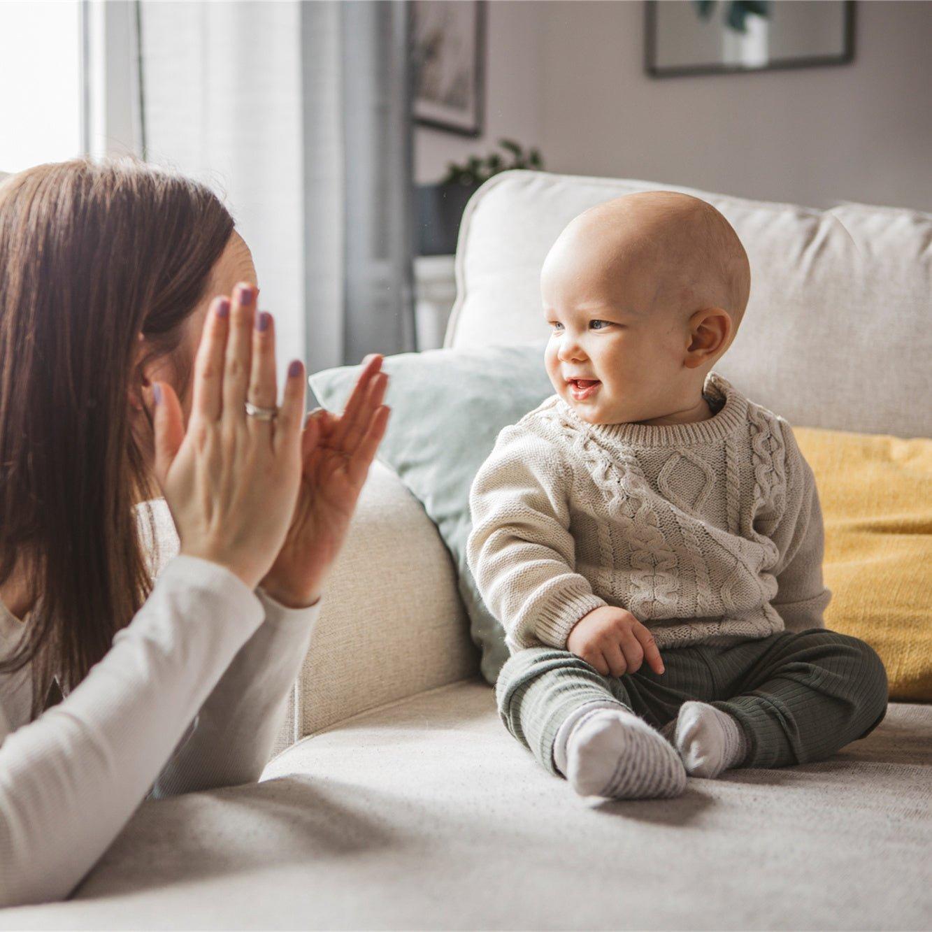 A mother is teaching baby with sign language