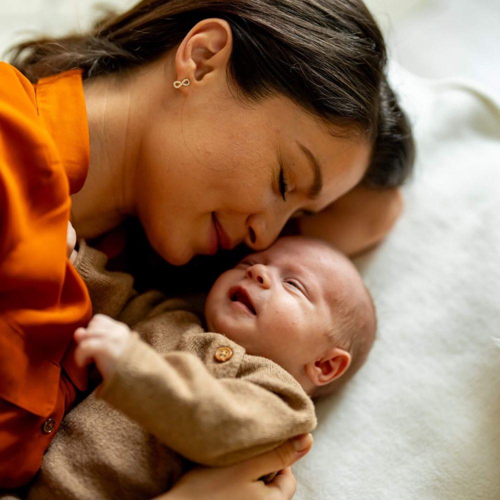 mother and baby napping at home