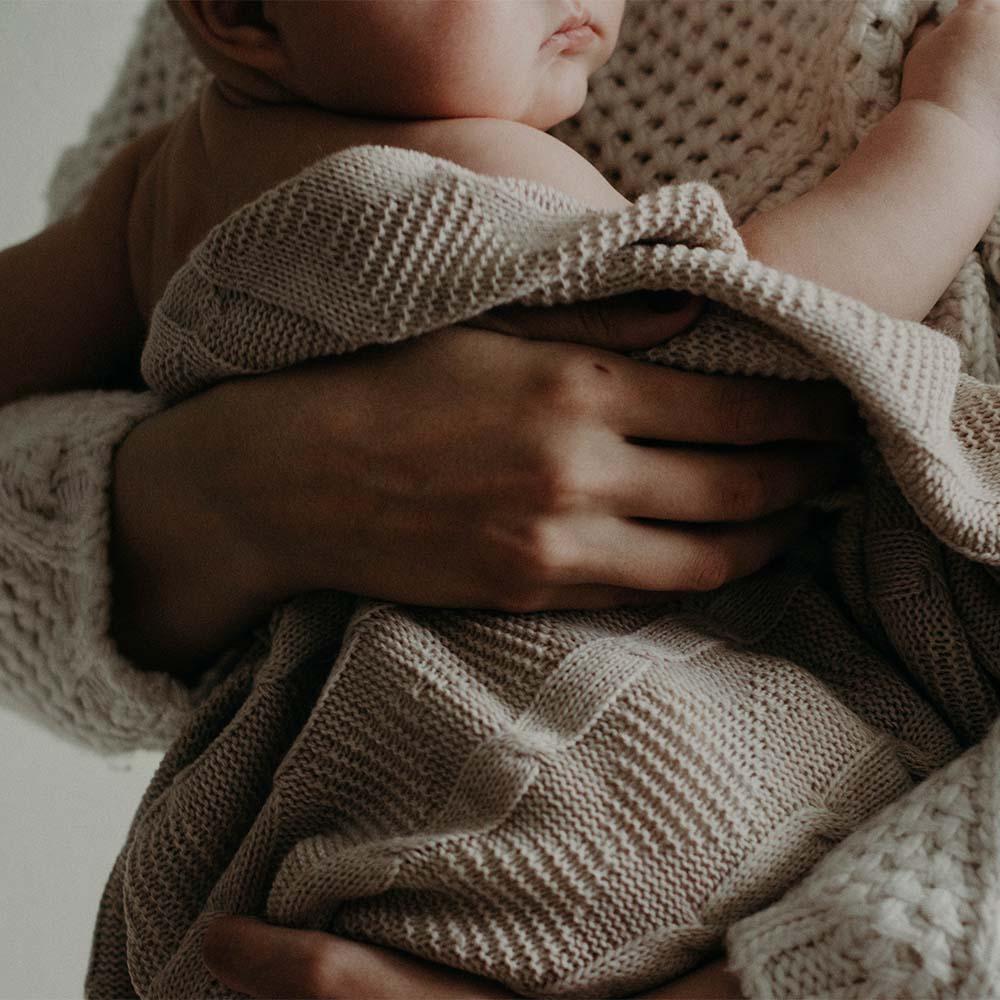 Exhausted mother taking care of baby