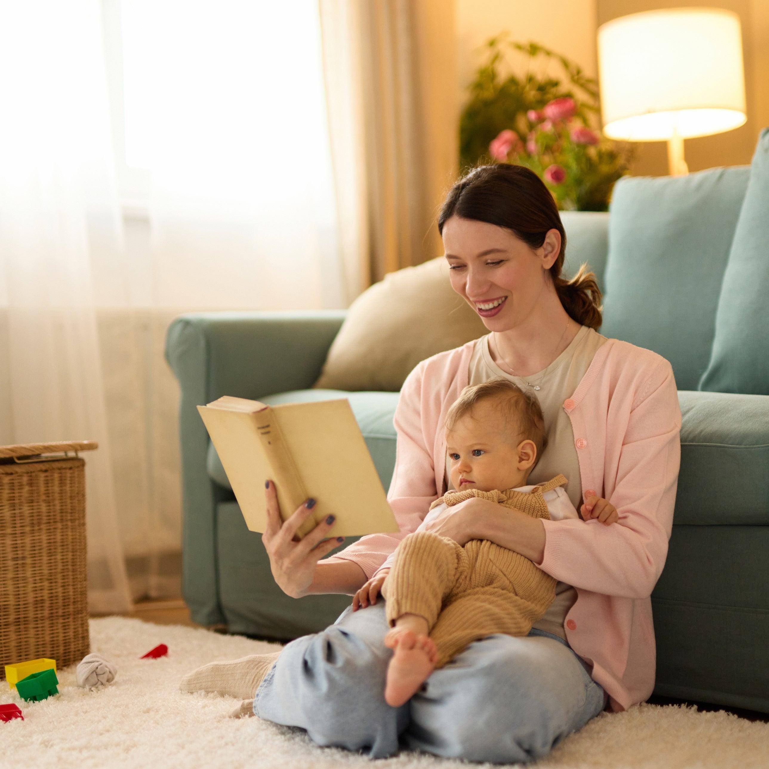Young mother reading a story to her baby boy at home