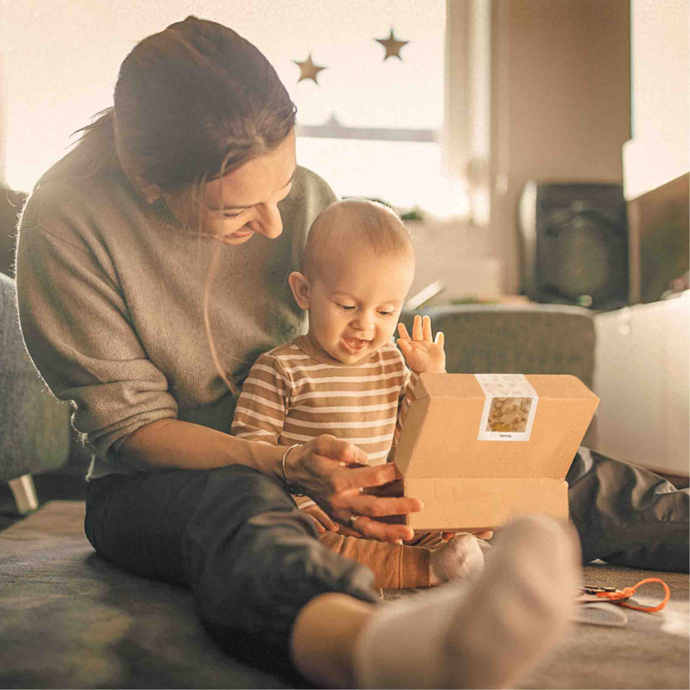 Baby looking happily at Standard Box From First Bites Gift Set 